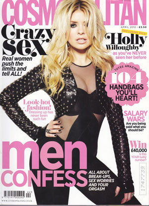 Woman in fitted black outfit with sheer panels and gold studs posing against a white background, styled with tousled blonde hair