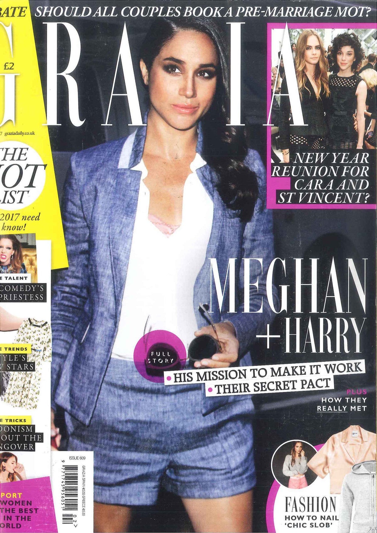 Woman in light blue plaid suit jacket and shorts with white blouse revealing pink camisole, holding sunglasses