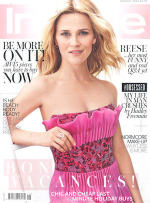 Medium close-up of a woman in a strapless bright pink dress with red and black floral bodice detail on a white background