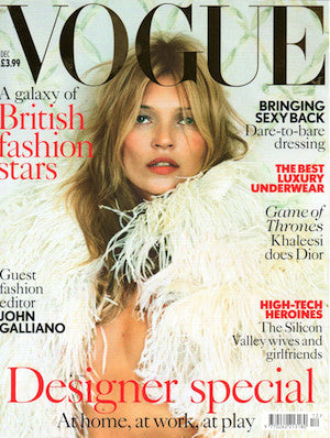 Close-up Vogue cover featuring a woman in a voluminous white feathered garment against a soft leafy background