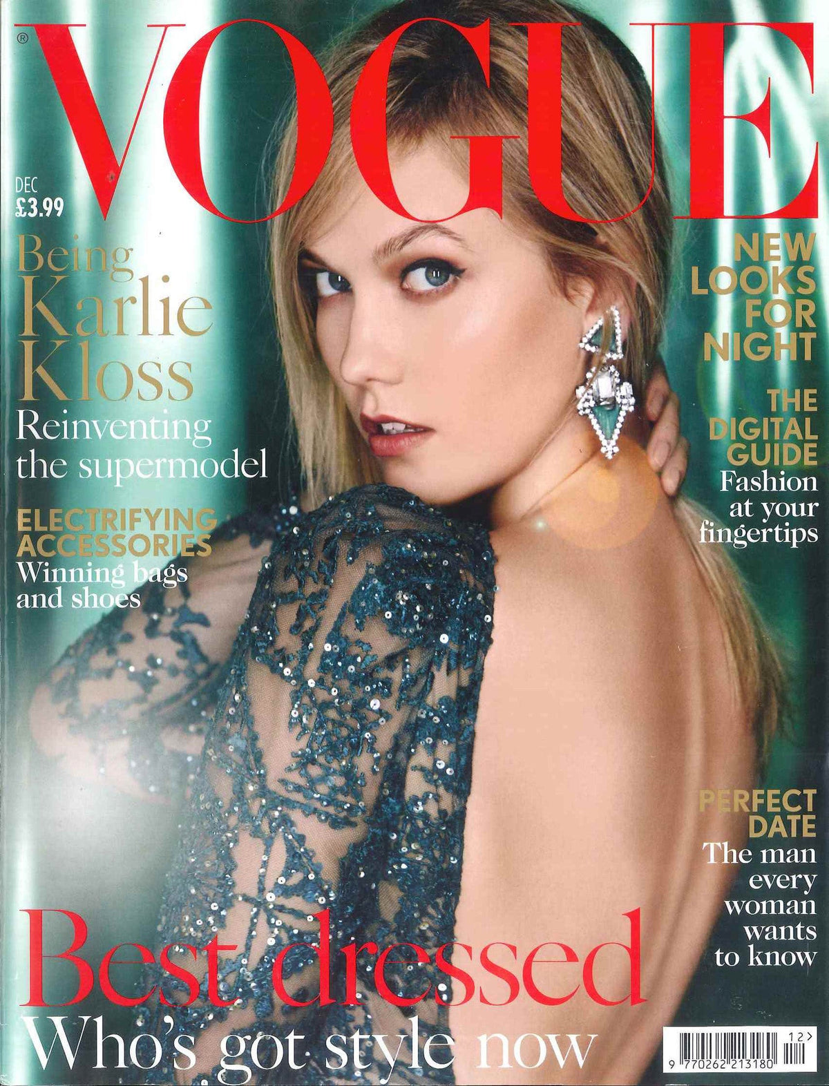 Close-up fashion portrait of a woman in a sheer dark blue sequined dress showing her bare back, wearing large geometric earrings